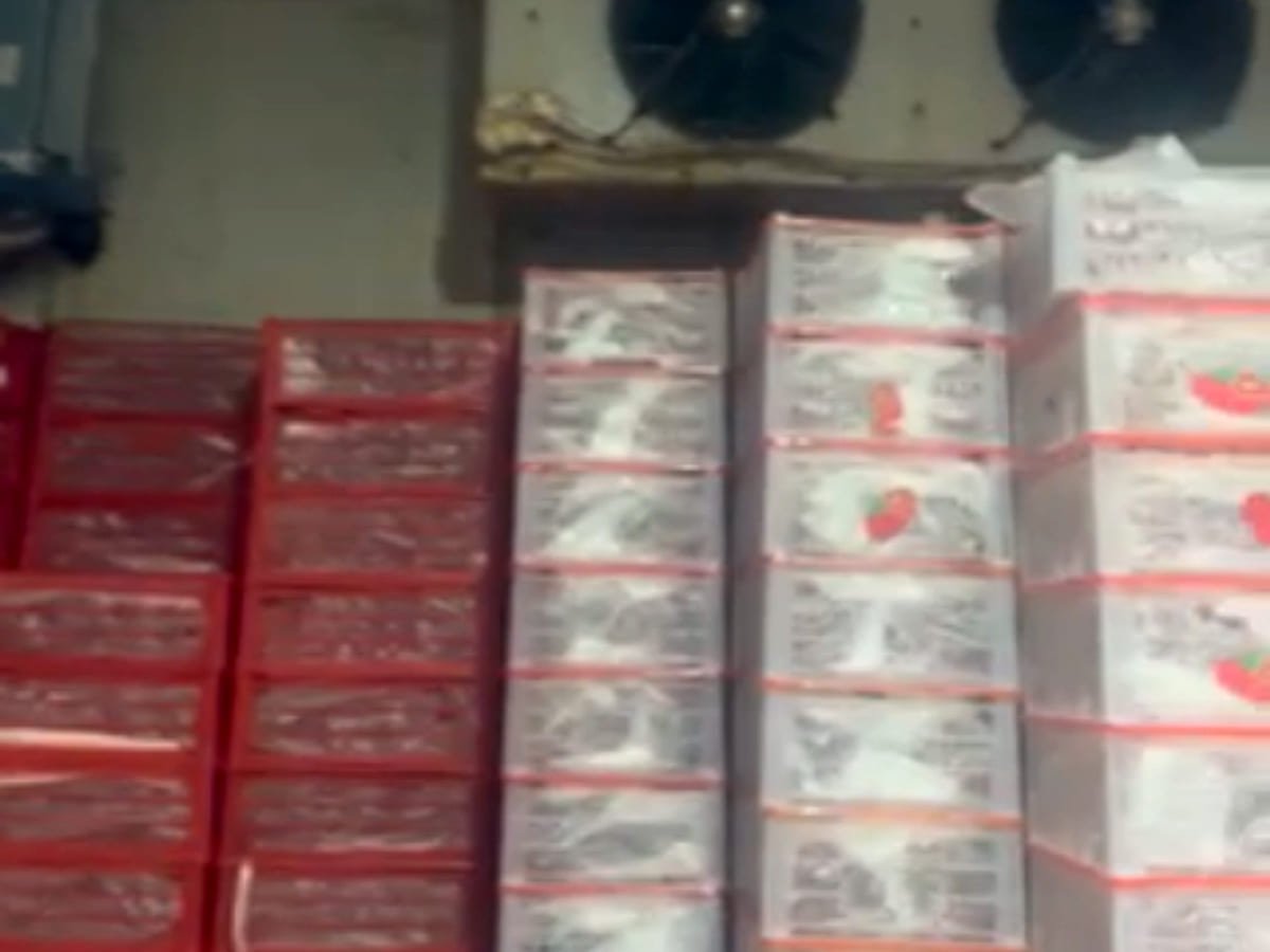 Ceiling evaporator running above crates of stock stacked inside a chiller room